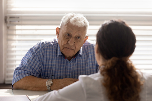 Close,Up,Anxious,Serious,Old,Man,Listening,To,Female,Doctor